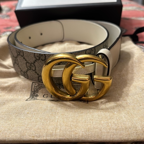 Tan gucci belt, with gold gucci sign, and black and brown gucci imprint on it. - Picture 1 of 11